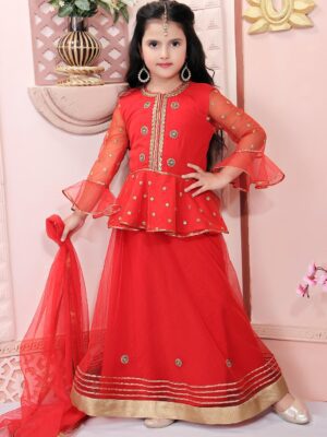 Nikhaar Creations Red Net Peplum Choli together With Embroidered Net Semi Bell Sleeves. And Peplum Embroidery Around Neck And Front Of Choli. Worn With Red Lehenga, Gold Tissue Brocade And Tissue In The Hemline Of The Peplum And Lehenga together With Red Net Dupatta. Having Gold Borders Around It.