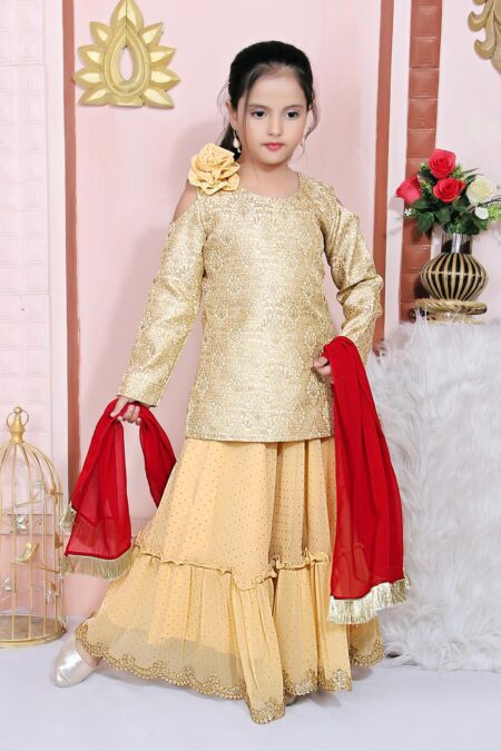 Nikhaar Creations Gold Brocade Short Lehenga Choli Kurti Cold Shouldered Full Sleeves With Gold Polka Dot Shimmer Georgette 2 Tiered Ghagra Having Kundan Stones Embroidered Border On Its Hemline With A Shimmer Floral Motif On Shoulder Worn With A Red Georgette Dupatta With Gold Fringes On Two Small Edges.