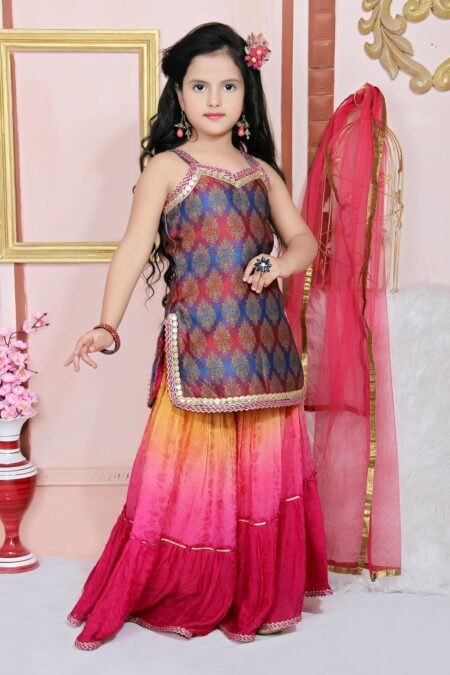 Nikhaar Creations Kids Multicolored Shaded Blue Reddish Pink Pure Banarasi Brocade Short Kurti Worn With Pink Shaded Crepe 3 Layered Sharara With Gathers Having Embroidered Border Detailings On The Neckline Slits Hemline Of Both Kurta And Sharara