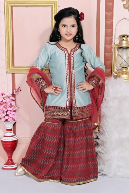 Nikhaar Creations Grey Chanderi Silk Kurta with Maroon Embroidery detailing on neckline, hemline and sleeves. Coupled with Maroon Handloom Sharara with gold detailing on the sharara hemline. With Maroon net dupatta with gold edges on all sides.